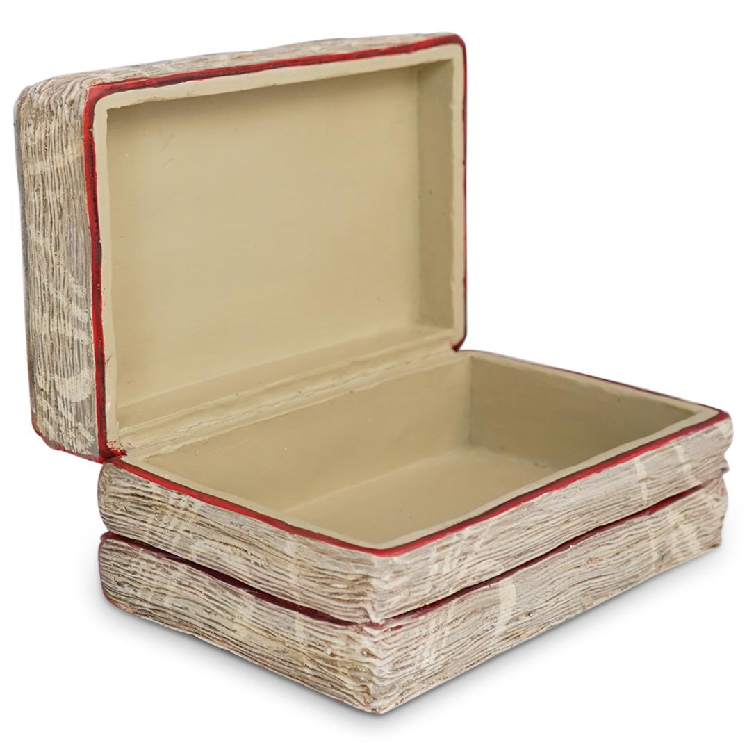 Books Trinket Box: DESCRIPTION: Trinket box with the design of a white and red striped pile of books. Made of resin like material with hand painted finish realistic motif. CIRCA: 20th Century. ORIGIN: USA. DIMENSIONS: L