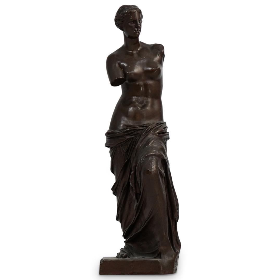 Venus De Milo Foundry Bronze: DESCRIPTION: A miniature Achille Collas bronze sculpture after the famous Greco-Roman sculpture:"Venus De Milo". Seen here nude with garments draped along her waist and finished in a soft brown patina