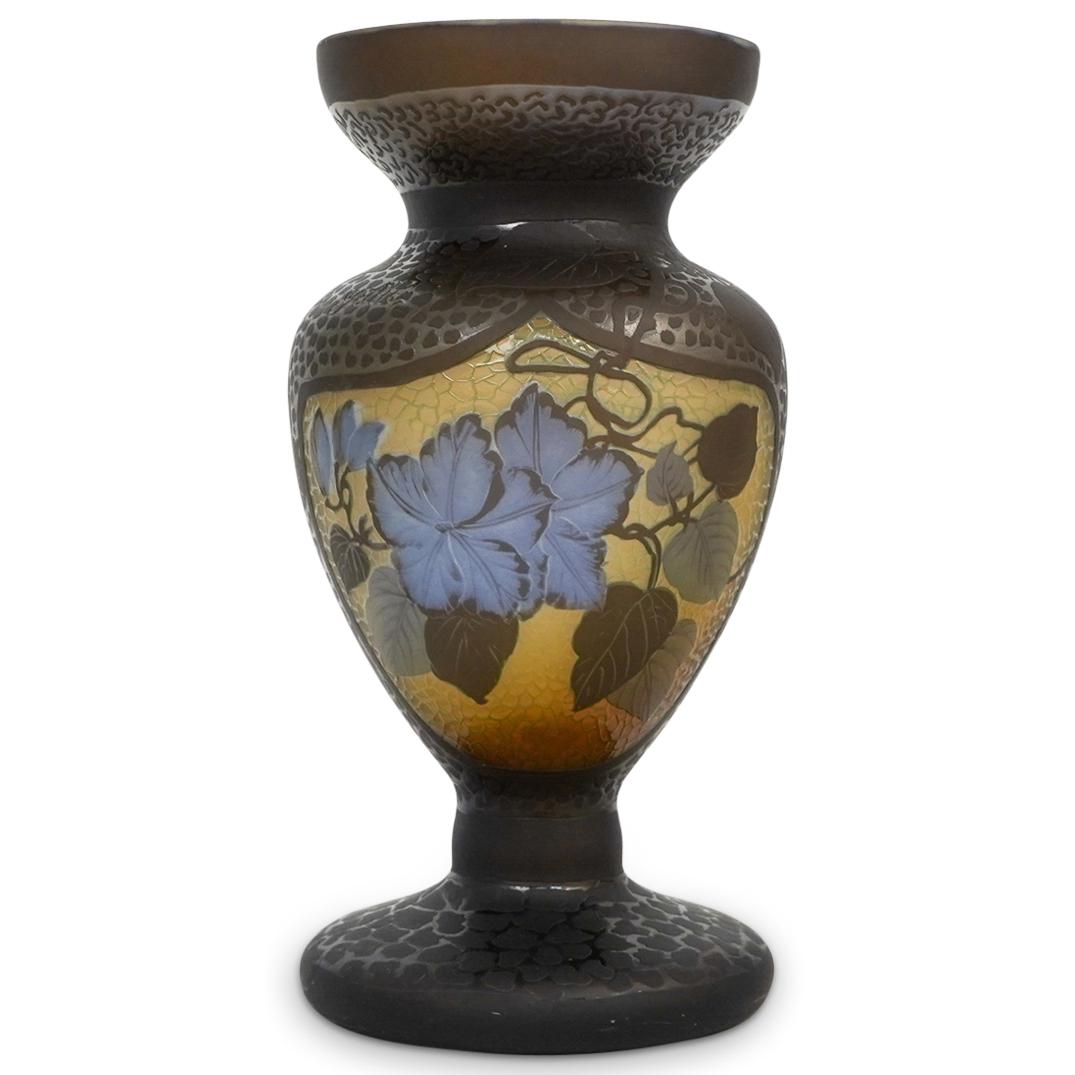 Emile Galle Style Cameo Glass Vase: DESCRIPTION: An Emile Galle style cameo cut glass vase. Features reliefs of blue flowers with scrolling green vine accents and a matte animal print pattern throughout. Signed "Galle" at top. CIRCA: 20
