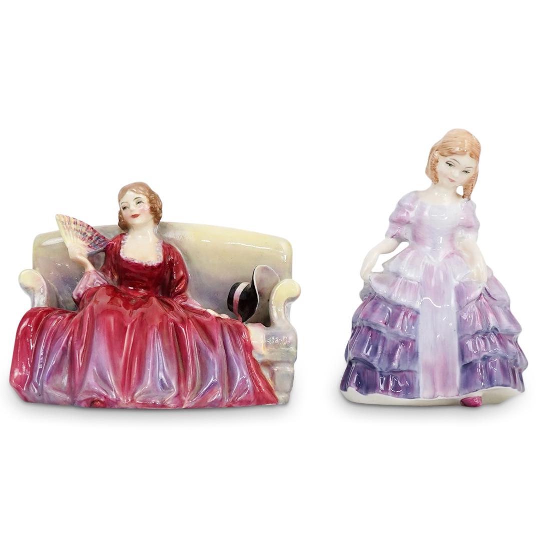 ( 2 Pcs) Pair of Small Royal Doulton Porcelain: DESCRIPTION: ( 2 Pcs) Pair of Small Royal Doulton Bone China Porcelain Lady Figurines. Hand crafted and hand painted porcelain figurines. One young lady wearing a lilac dress and a second figurine sea