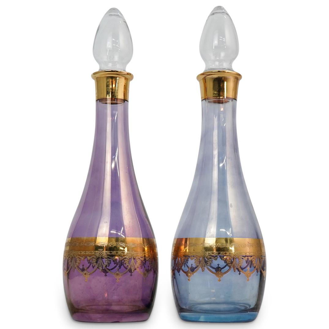 (2 Pc) A Pair of Italian Glass Decanters: DESCRIPTION: (2 Pc) A Pair of italian glass decanters. Crafted in elegant purple and blue colored glass and further embellished with gold gilt foliage and garland decorative motif. CIRCA: 21st Century