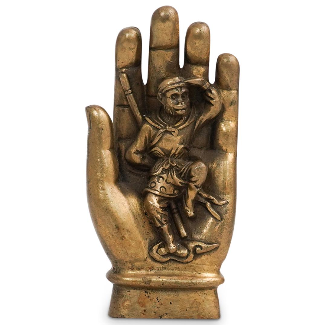 Chinese Monkey In Hand Bronze: DESCRIPTION: A Chinese bronze depicting a monkey in decorated garb within a figural hand. Cast with intricate details and finished with a gilt patina. Character markings on reverse. CIRCA: 20th Cent. 