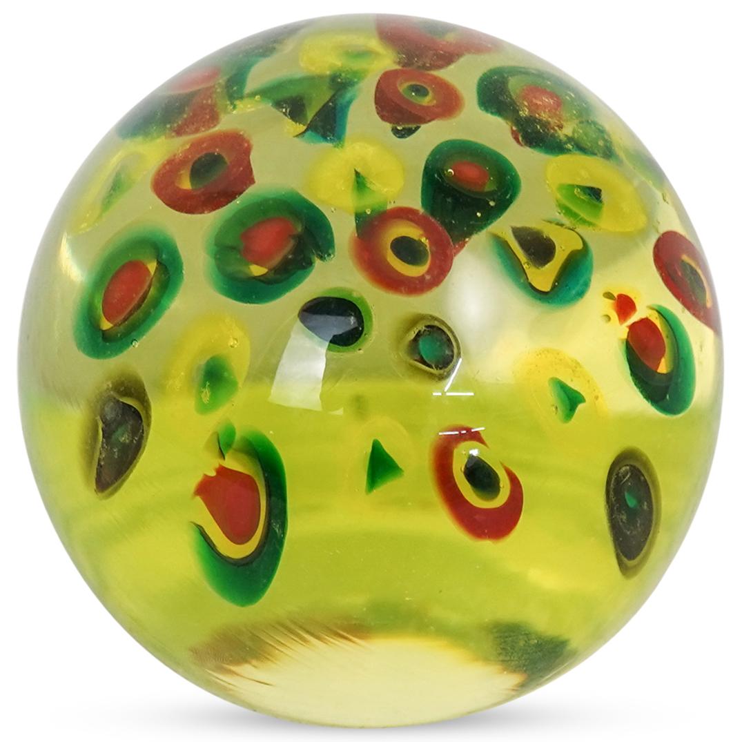 Murano Glass Millefiori Paperweight: DESCRIPTION: A Murano glass blown paperweight with greenish hues and suspended millefiori designs. CIRCA: 20th Cent. ORIGIN: Italy DIMENSIONS: H: 3.5" x D: 3.5" CONDITION: Great condition. See lot des