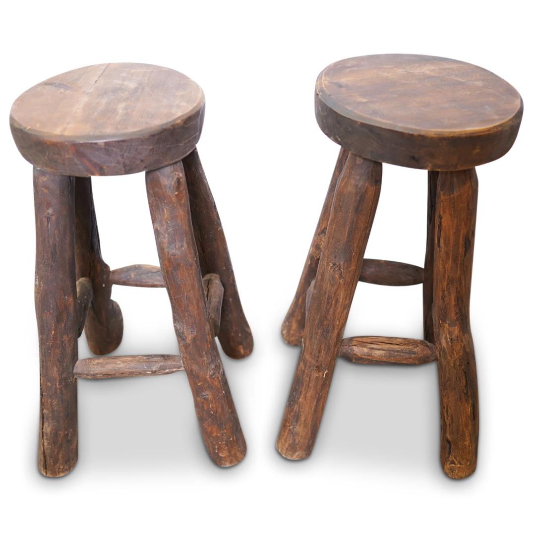 Mexican Carved Wood Stools: DESCRIPTION: A pair of Mexican natural brown wood carved stools. Stamped: "Mexico" CIRCA: 20th Cent. ORIGIN: Mexico DIMENSIONS: H: 30" x D: 24" (Seat) D: 14.25" CONDITION: Great condition. See lot des