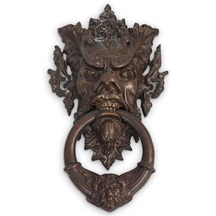Figura Bronze Gargoyle Door Knocker: DESCRIPTION: A figural cast bronze door knocker. Features a figural gargoyle design with intricate cast leaf accents and a loose ring knocker. CIRCA: 20th Cent. ORIGIN: Continental DIMENSIONS: H: 16"