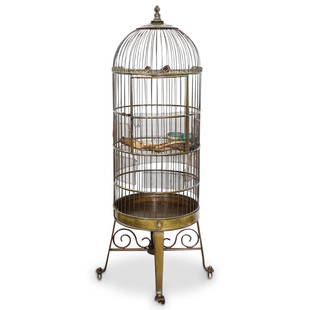 Italian Birdcage By "D. Schieve": DESCRIPTION: An antique bronze Italian birdcage by "D. Schieve" Features a dome form with hinged door and pull out tray. Rests on a four caster rolling base. Complete with two Chinese cloisonne bird