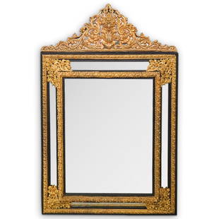 Italian Ornate Rococo Mirror: DESCRIPTION: An antique Rococo style mirror. Features a wood foundation with ornate gilt metal scrolling details. Designed with four mirror panales surrounding a center inset beveled mirror. CIRCA: