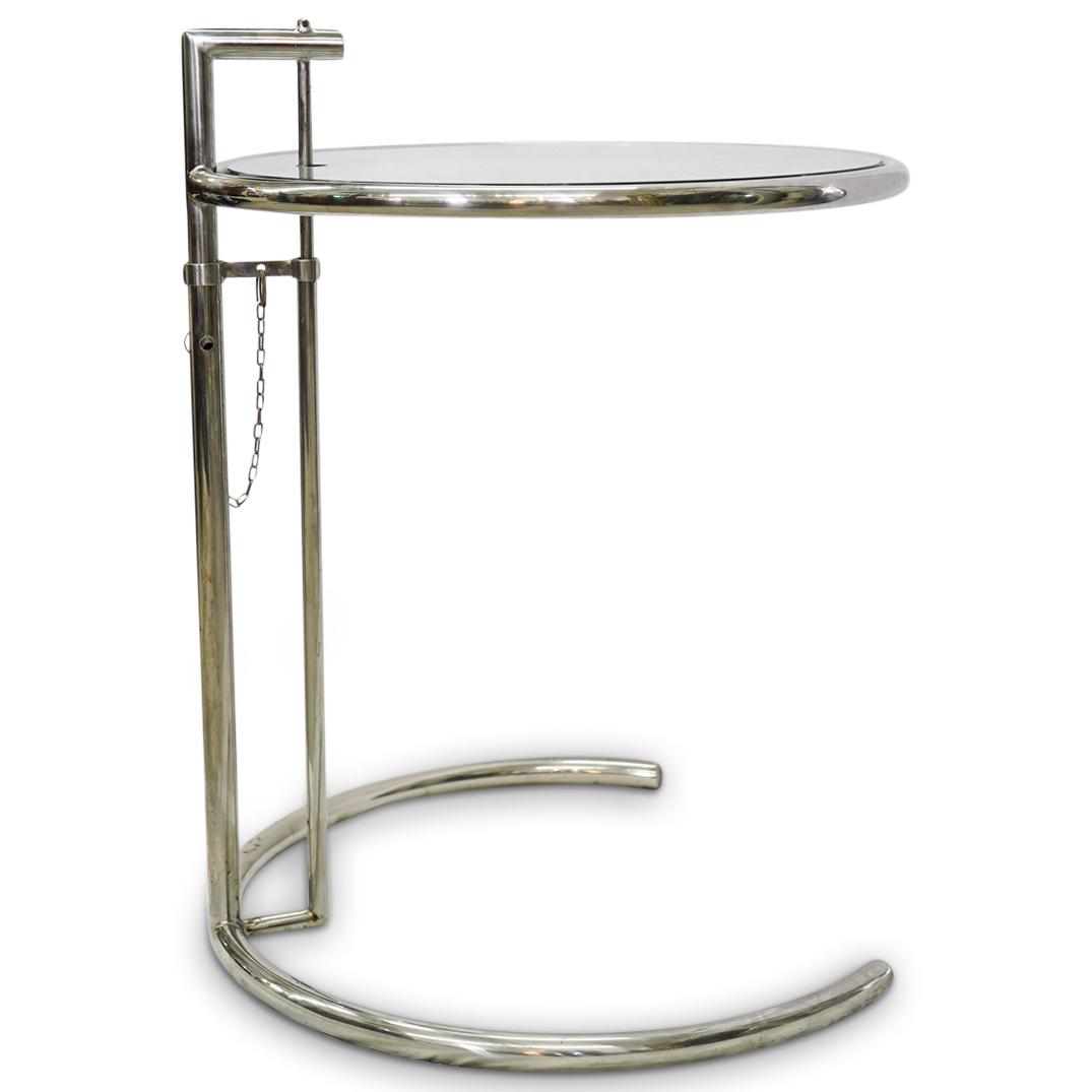 Eileen Gray ClassiCon Adjustable Table: DESCRIPTION: ClassiCon adjustable chrome and glass table, Designed with steel tubing and glass top. CIRCA: 20th Century. ORIGIN: Germany DIMENSIONS: H: 25" W: 20" CONDITION: Good condition. See lot de