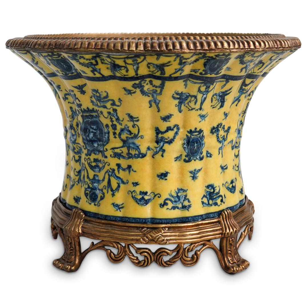 "United Wilson" Porcelain Jardiniere: DESCRIPTION: A Vintage Large "United Wilson" Porcelain Jardiniere. This is a hand painted heavy porcelain vase jardiniere with yellow and blue design on the exterior, scalloped metal rim and raised up