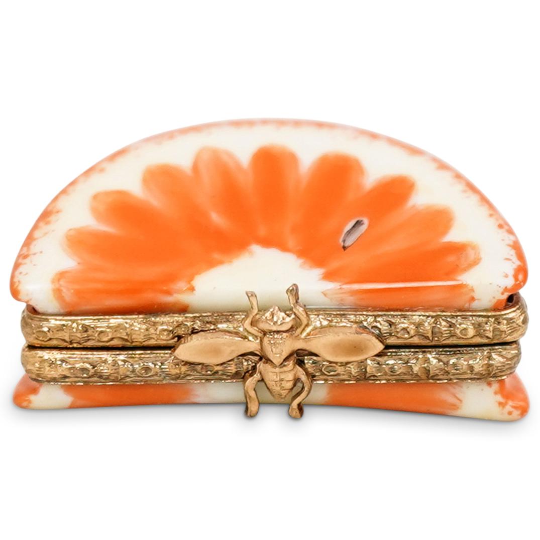 Limoges Orange Sliced Porcelain Trinket Box: DESCRIPTION: Limoges Orange Sliced Porcelain Trinket Box. Marked on interior: "Peint Main Limoges France". CIRCA: 20th Century. ORIGIN: France. DIMENSIONS: H: 3/4" W: 1 1/2". CONDITION: Good condition