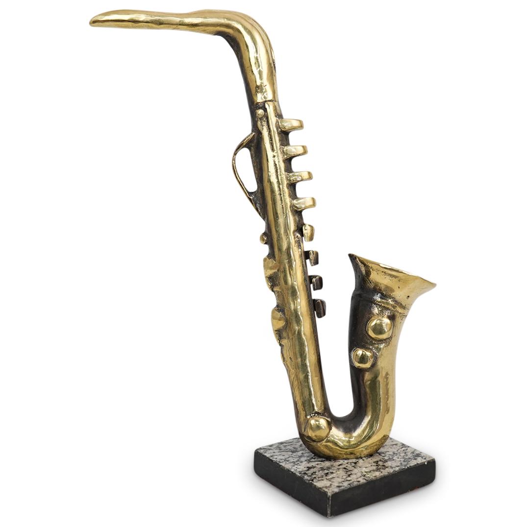 Bronze Saxophone Sculpture: DESCRIPTION: A bronze sculpture depicting a saxophone executed in a brutalist fashion. Mounted to a square granite base. CIRCA: 20th Cent. ORIGIN: Continental DIMENSIONS: H: 13.75" x D: 10" Have a sim