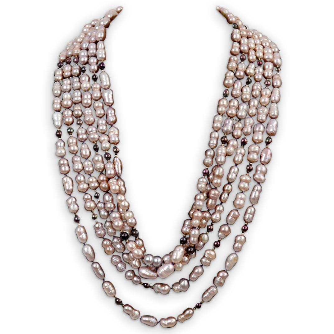 Triple Strand Pearl and Gold Necklace: DESCRIPTION: A triple strand necklace with pink and Tahitian pearls, designed with an ornate open work yellow gold clasp CIRCA: 20th Cent. ORIGIN: Continental DIMENSIONS: (Necklace Closed: L: 26.5" x 