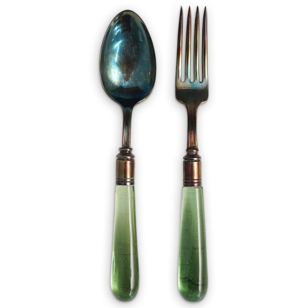 Steuben Green Glass Sterling Flatware: DESCRIPTION: Steuben flatware featuring a fork and spoon with Spanish green bubbly glass handle on gold varnish sterling silver foundations. Lead glass with attached gold-plated hardware. Reference: S