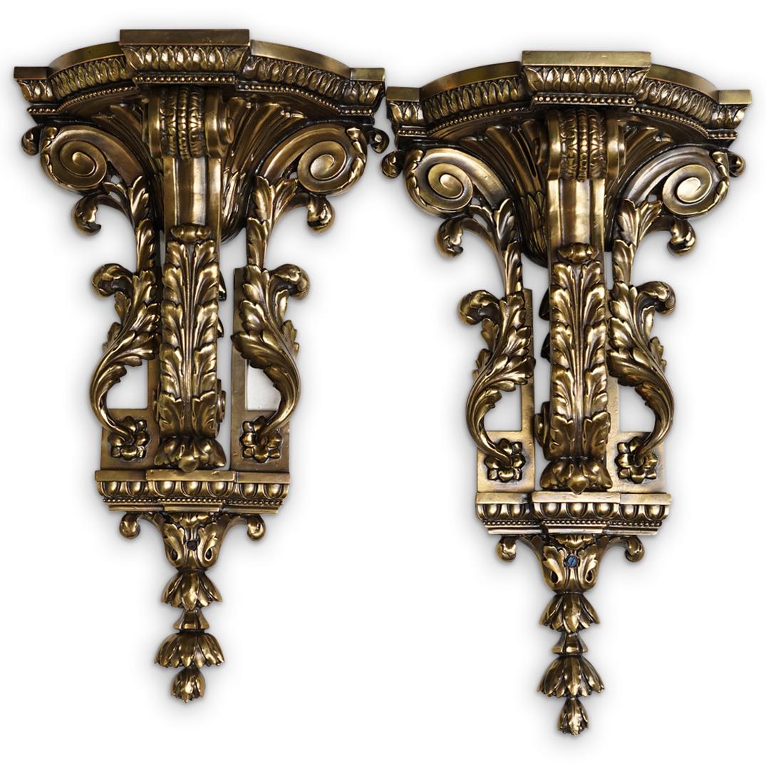 Pair of Ornate Metal Brackets: DESCRIPTION: A pair of ornate copper toned metal wall brackets with scrolling acanthus leaf designs. CIRCA: 20th Cent. ORIGIN: Continental DIMENSIONS: H: 23.5" x W: 13.5" x Depth: 6.5" Have a similar 