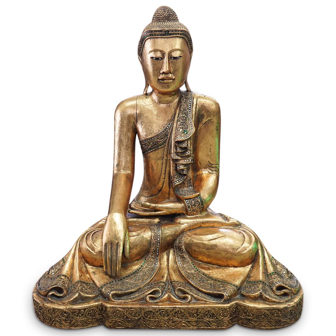 Carved Gilt Wood Seated Buddha: DESCRIPTION: A carved Thai gilt wood seated buddha. Wearing a monk's robe, gilded with inlaid mirrored glass accents overall. CIRCA: 20th Century ORIGIN: Thailand DIMENSIONS: H: 35" W: 31" CONDITION: 