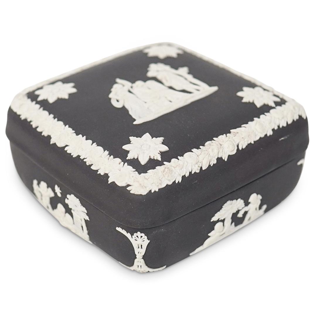 Wedgwood Black Basalt Jasperware Trinket Box: DESCRIPTION: A square Wedgwood black basalt jasperware trinket box with a white bas relief detailing featuring a classical figural scene. The trinket box is stamped on the base "Wedgwood" and "Made In