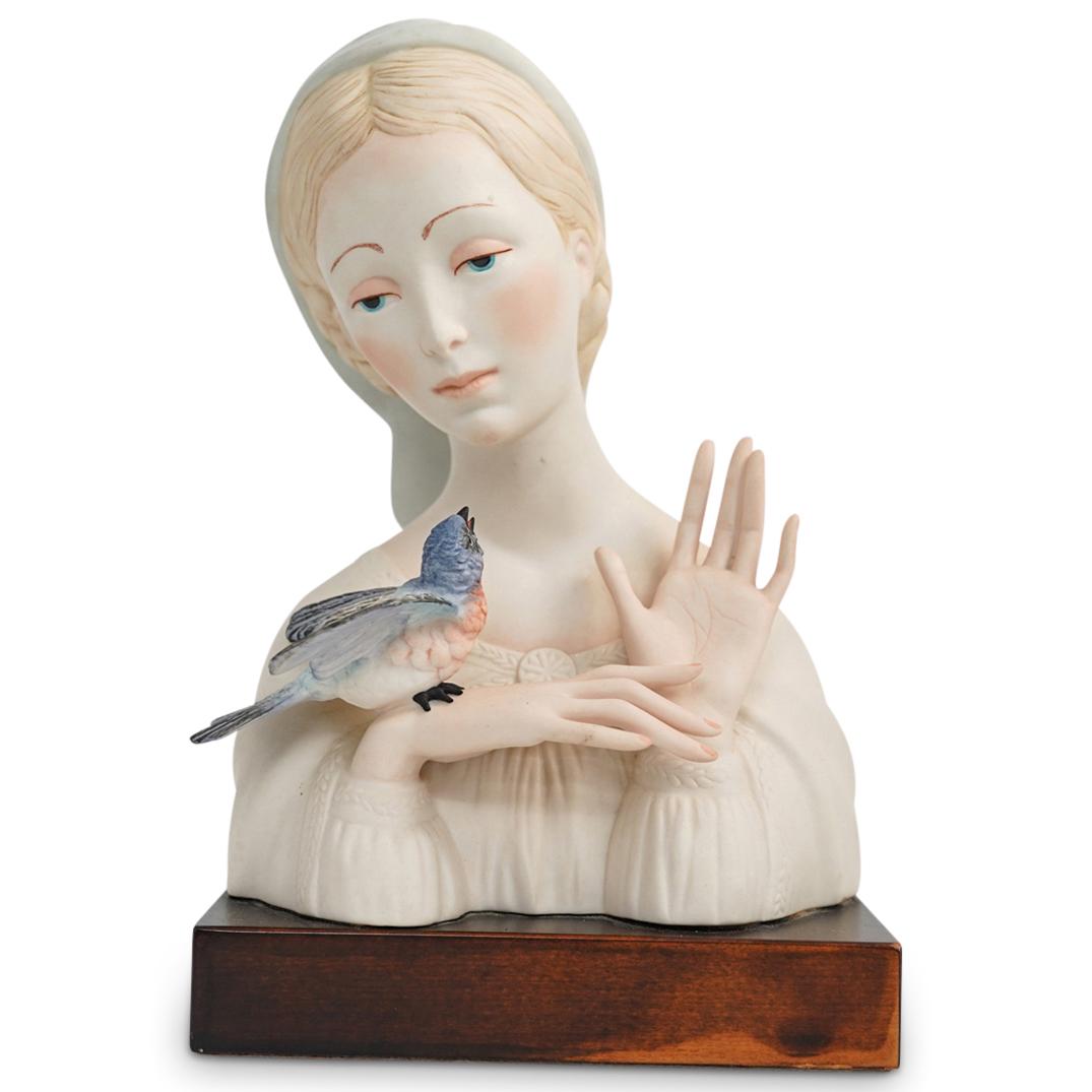 Cybis Porcelain "Madonna with Bird" Bust Figure: DESCRIPTION: A Cybis "Madonna with Bird" porcelain bust. This is a signed porcelain bust of the Madonna with a hand painted colorful bird posing over her right hand. The sculpture sits atop a wooden b