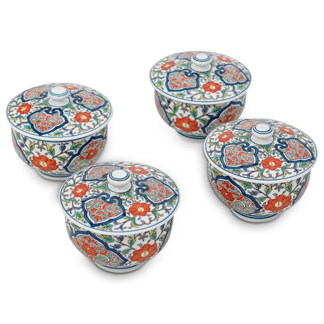 (4 Pc) Japanese Porcelain Lidded Tea Cups: DESCRIPTION: Japanese porcelain lidded tea cups featuring in a white ground color and decorated with floral vine motifs, marked along the underside with blue markings. CIRCA: Early-Mid 20th Cent. ORIG