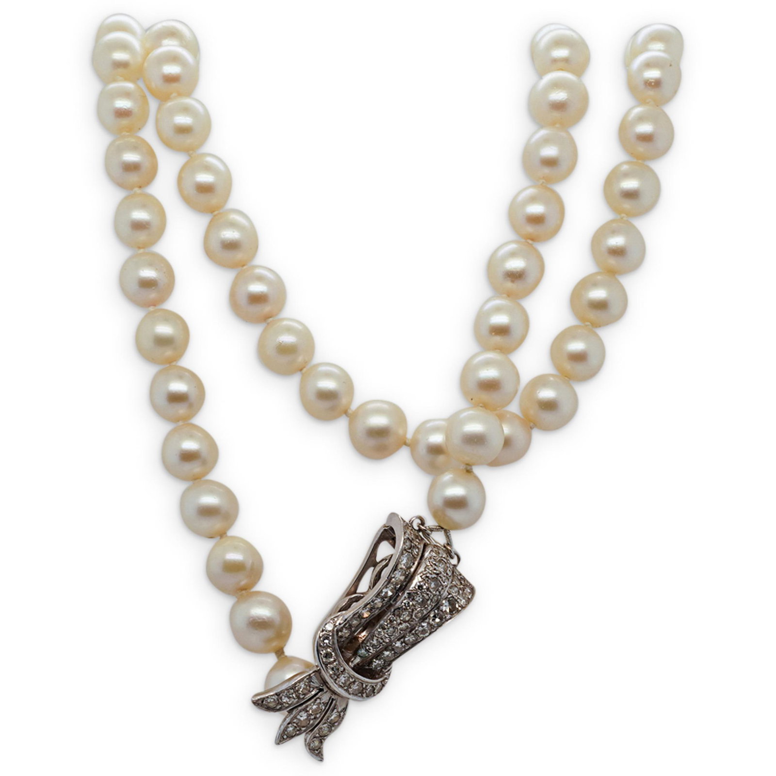 14K White Gold, Diamond, & Pearl Necklace: DESCRIPTION: A white 14K gold diamond set bow and buckle formed necklace with natural pearl stand. Stamped: "14KT" CIRCA: 20th Cent. ORIGIN: USA DIMENSIONS: L: 13.5" Total Weight: 64 Grams CONDITION: 