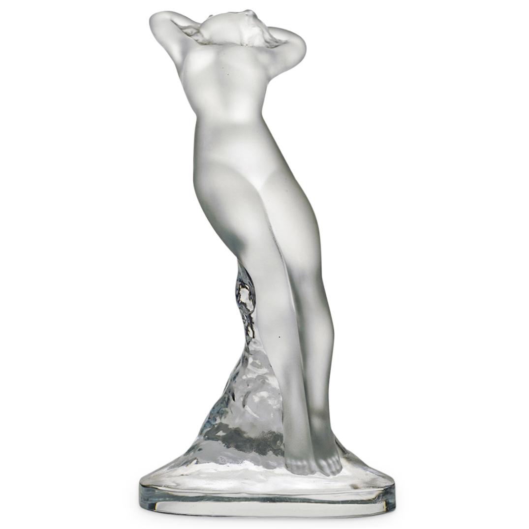 Lalique Reclining Nude Lady Sculpture: DESCRIPTION: A Lalique Reclining Nude Lady sculpture. This is an art sculpture in frosted glass depicting a nude female figure with raised arms and twisted torso, posing atop a clear base. It is craft