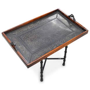 Maitland Smith Leather Embossed Tray with Stand: DESCRIPTION: "Victorian Library Tray" composed of wood, leather wrapped and brass handles featuring gripping hands. Sits atop expandable metal stand. CIRCA: 20th Century. ORIGIN: Continental DIMENSION