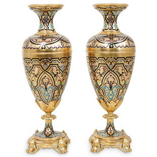 Pair of French Champleve Enamel & Gilt Bronze Vases: DESCRIPTION: (2 Pc) A Pair of french gilt bronze & champleve enamel garniture urn vases with leaf mounts on plinth circular bases decorated with interlaced decorative motifs. This magnificent pair of