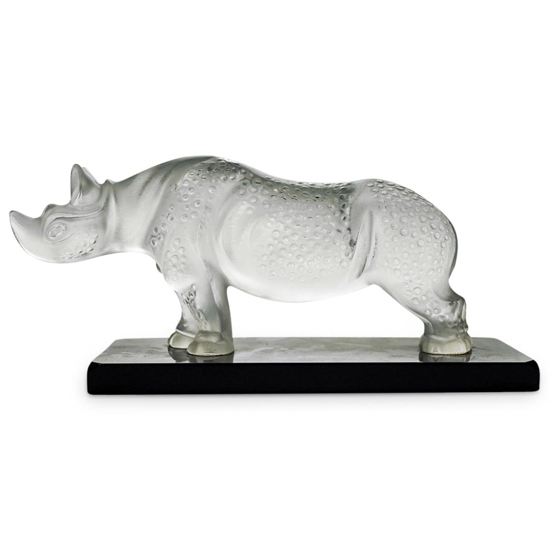 Lalique Frosted Crystal Rhinoceros: DESCRIPTION: Lalique frosted crystal Rhinoceros on black glass base. Large crystal Rhino done in frosted crystal with a textured body. Singed along the side of marble base "Lalique France"/ CIRCA: 20t