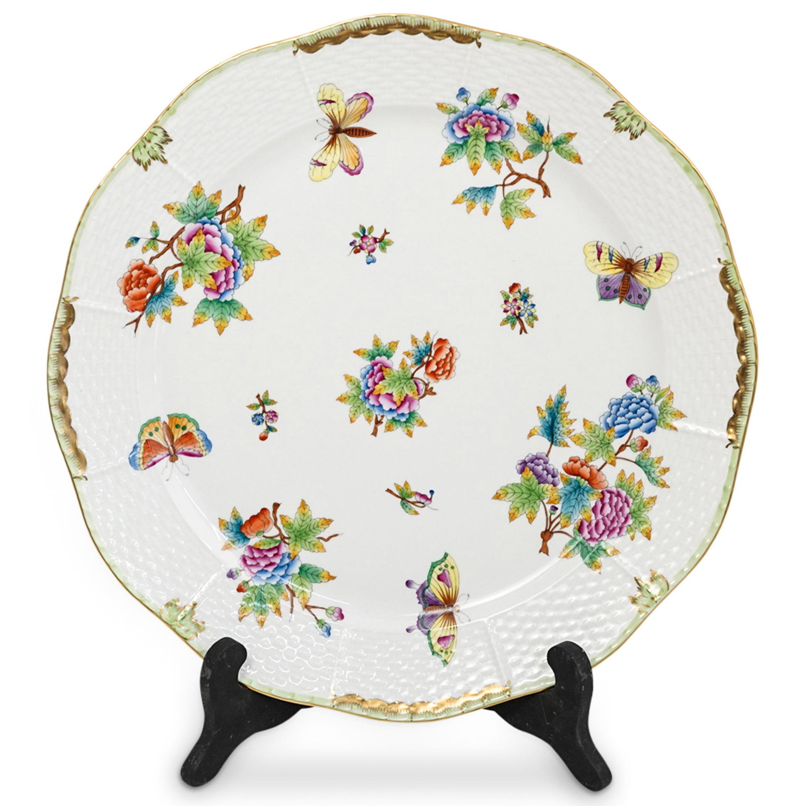 Herend Porcelain Queen Victoria Charger: DESCRIPTION: A Herend porcelain large dessert plate in white ground porcelain decorated with hand painted decorations in green, blue and gilt colors depicting floral and butterflies motifs. Marked "He