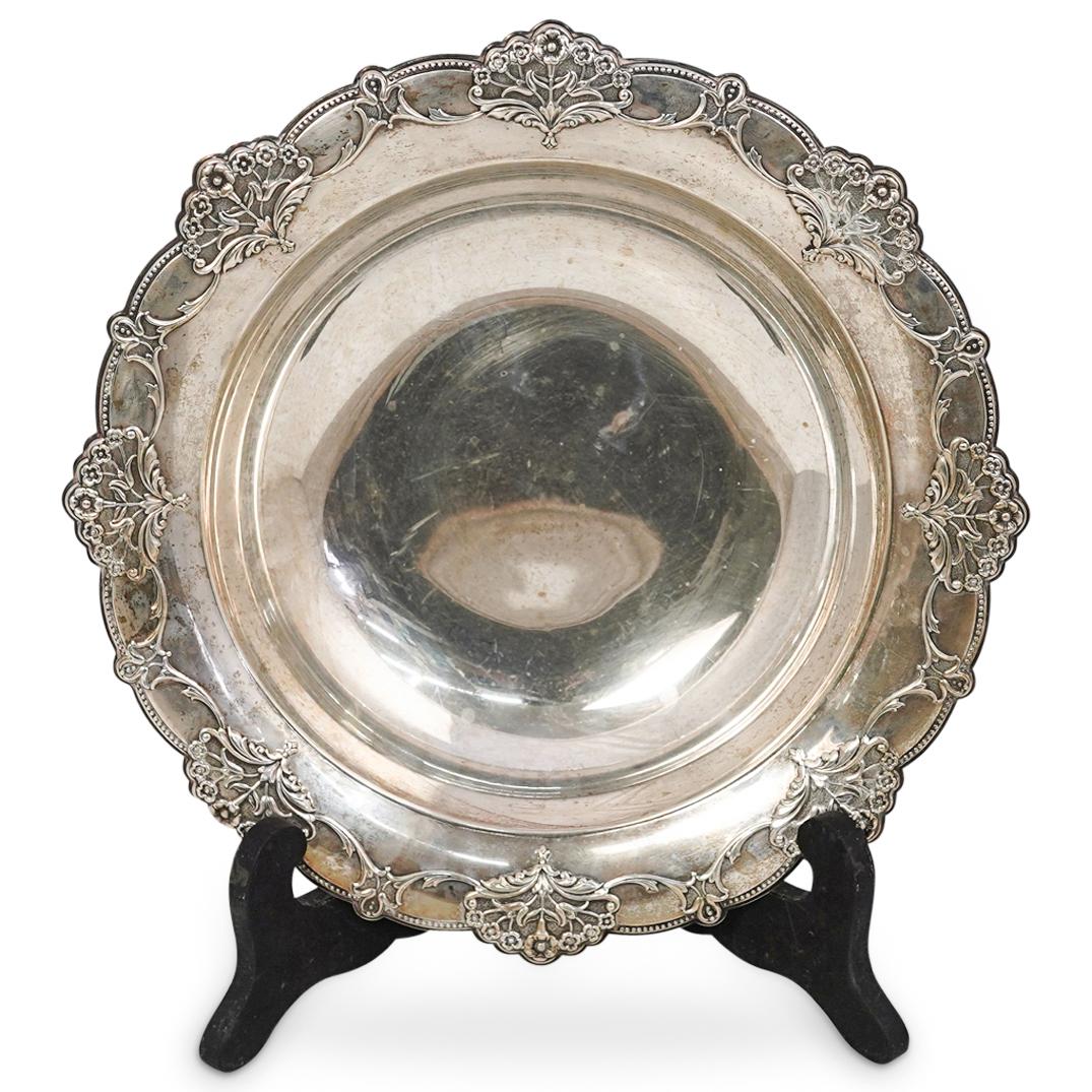 International Sterling Bowl: DESCRIPTION: An International sterling silver bowl with repousse blooming daisy decorated rim. Hallmarked: "International Sterling, D321" CIRCA: 20th Century. ORIGIN: USA DIMENSIONS: H: 2" x D: 11" (T
