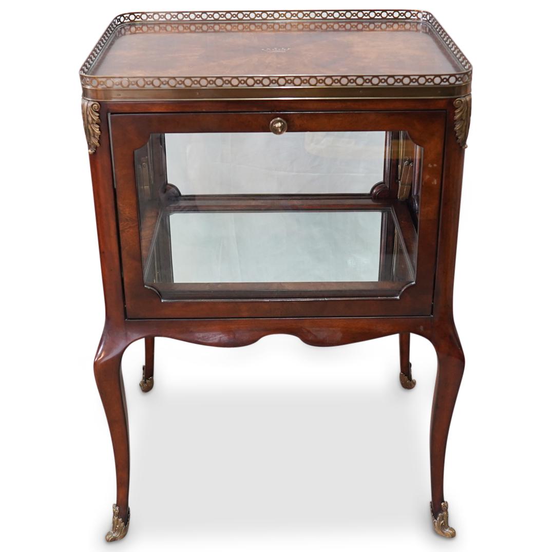 Althorp Wood and Glass Display Vitrine: DESCRIPTION: An Althrop display vitrine comprised of wood and four glass panels, each hinged panel opens vertically revealing a mirrored base interior. Further decorated along the corners with brass f