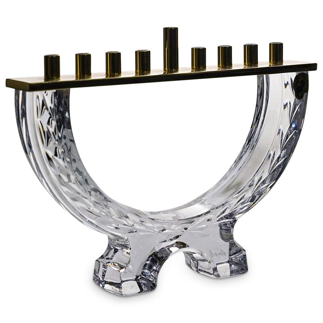 Waterford Crystal and Brass Menorah: DESCRIPTION: A Judaica Waterford crystal Menorah crafted in clear crystal and brass from the Waterford Judaica Giftware collection. Marked with the engraved "Waterford" hallmark, signature and date. C