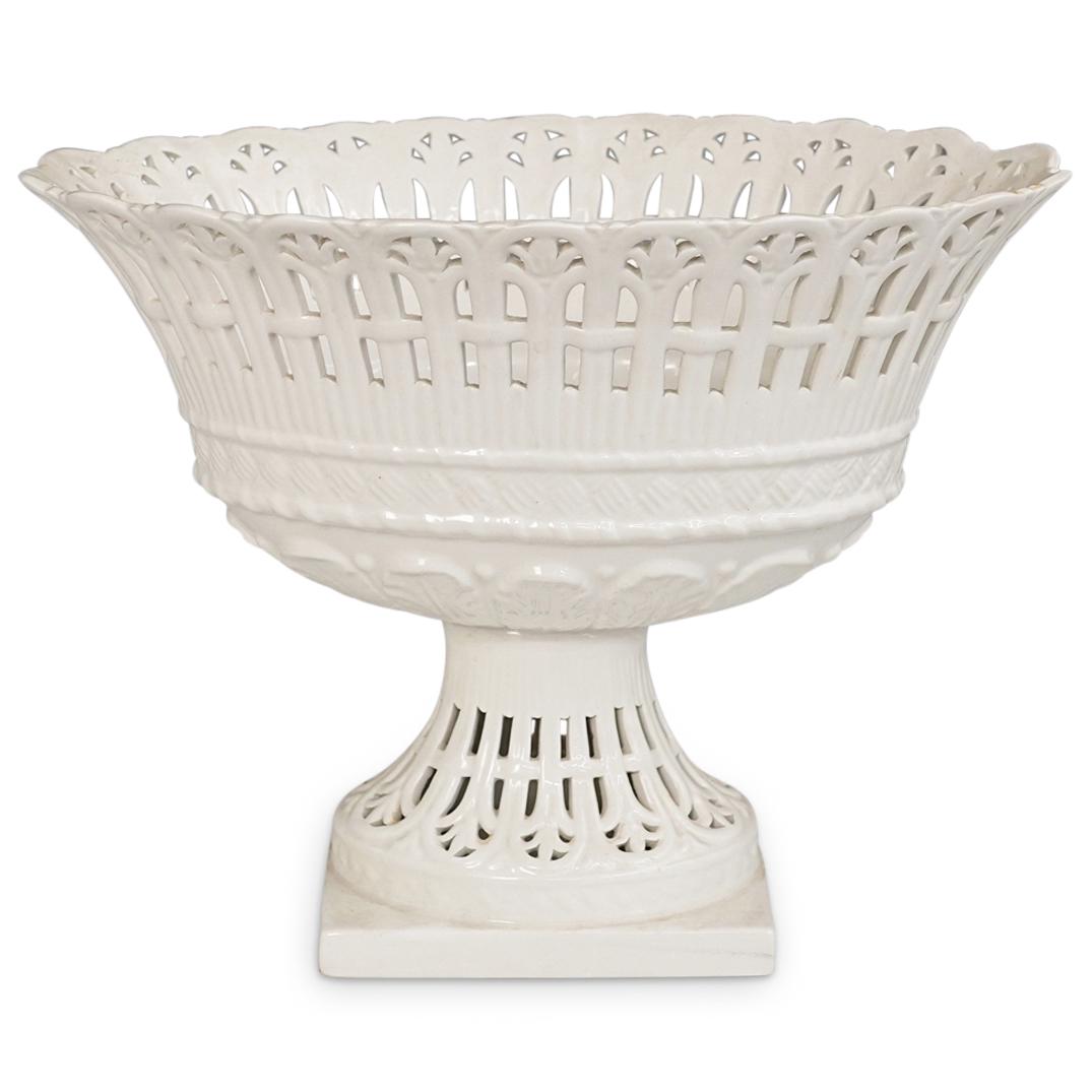 European Porcelain Centerpiece: DESCRIPTION: A European porcelain centerpiece features reticulated rim and base, completed in an egg white gloss glaze finish. CIRCA: 20th Century. ORIGIN: Europe DIMENSIONS: H: 10" W: 13" Have a simi
