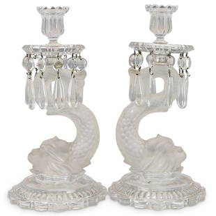 Pair Baccarat Dolphin Glass Candle Holders: DESCRIPTION: (2 Pc) A Pair of large french Baccarat art glass candle holders in clear glass with a frosted Dolphin Koi Fish figure resting atop a circular glass base with a scalloped edge. Each