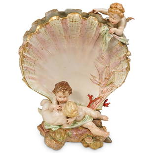 Antique KPM Figural Clam Shell Vase: DESCRIPTION: KPM porcelain vase featuring two cherubs embracing one another on the base of a shell surrounded by small shells and coral. Finished with glossed glaze and marked:"KPM" CIRCA: Late 19th