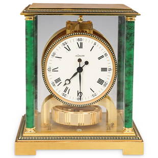 LeCoultre Atmos Malachite Mantle Clock: DESCRIPTION: A rare LeCoultre Atmos malachite mantel clock with a gold metal case adorned with malachite columns at each corner. This is a perpetual motion clock that never needs winding. It operates