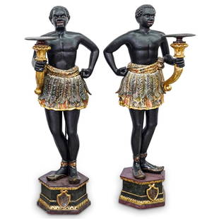 Large Wood Carved Blackamoor Sculptures: DESCRIPTION: A pair of monumental Venetian blackamoors. Features two figures holding torchieres with polychrome and gilt accents, CIRCA:19th Cent. ORIGIN: Italy DIMENSIONS: H: 60" W: 20" Depth: 15" Ha