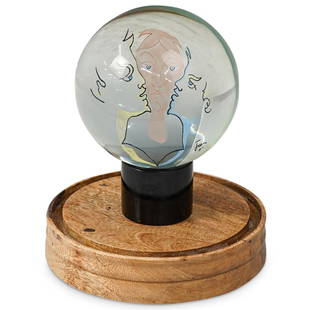 Jean Cocteau (French, 1889-1963) Glass Sculpture: DESCRIPTION: A Jean Cocteau glass sculpture features a glass sphere with multicolored figures along the interior, completed atop a cylindrical base. Sits inside a glass and wooden dome. CIRCA: Mid