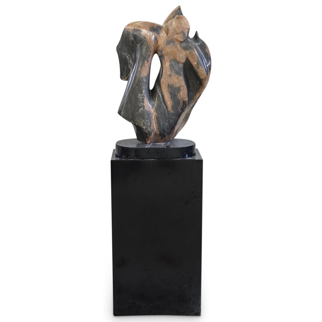Sherryl Hollander (American) "Fantasy Flight" Alabaster: DESCRIPTION: A Sculpture by Sherryl Hollander titled "Fantasy Flight" composed of Tiger Eye Alabaster. Fitted atop a black slate base and sitting atop a large rectangular pedestal. Comes with Letter o