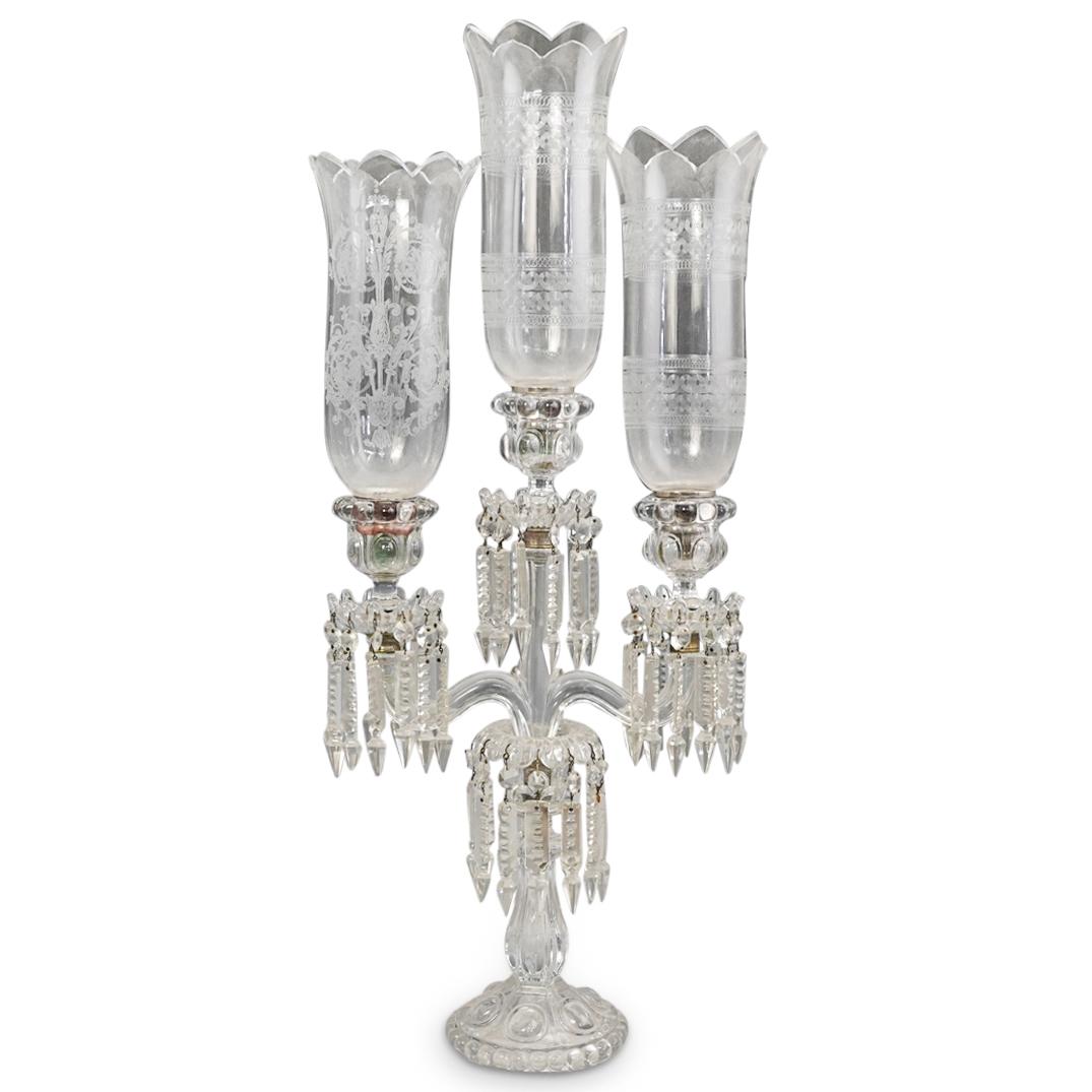 Antique Crystal Cut Hurricane Glass Candelabra: DESCRIPTION: An Antique glass crystal cut candelabra features three candle arms, each decorated with inset bobeche with hanging crystal prisms, fitted with glass hurricane with etched designs. CIRCA: 