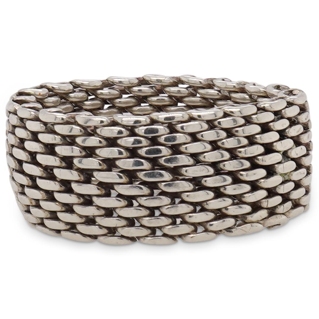 Tiffany and Co. Sterling SIlver Mesh Ring: DESCRIPTION: A Tiffany and Co. Sterling silver Mesh Ring stamped along the back "T&co 925". Total Weight: 8.5 Grams (Comes with Pouch) CIRCA: 20th Century. ORIGIN: USA DIMENSIONS: Ring Size: 8 Have a