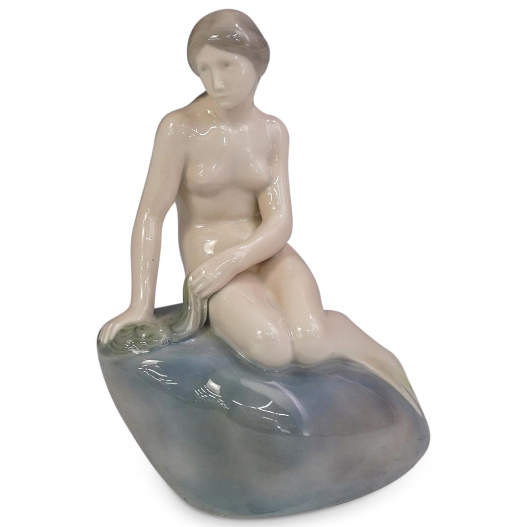 Royal Copenhagen Edvard Eriksen Porcelain Mermaid: DESCRIPTION: Royal Copenhagen mermaid on rock porcelain glazed figural porcelain sculpture by Edvard Eriksen. Royal Copenhagen markings underneath "4431, Denmark" Signed: "Edvard Eriksen" at side. CIR
