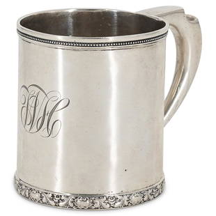 Tiffany & Co. Sterling Silver Cup: DESCRIPTION: Tiffany & Co. sterling silver handled cup with floral designs along the bottom and beaded pattern along the rim. Hallmarked: "Tiffany & Co. 2202, M, 8389, Sterling Silver" CIRCA: 19th