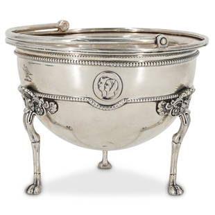 Tiffany & Co. Sterling Silver Footed Bowl: DESCRIPTION: Tiffany & Co. sterling silver footed bowl with top hinged handle. Features center figural decorations along the body with ornate floral motif animalistic formed legs. Engraved with bird