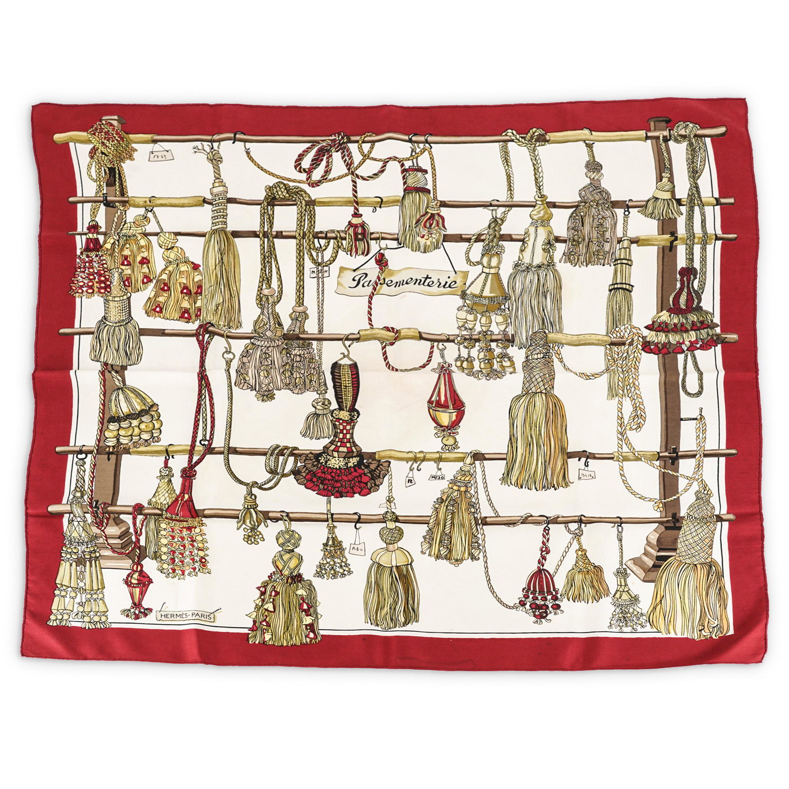 Francoise Heron Hermes Passementerie Silk Scarf: DESCRIPTION: HermÃ¨s silk scarf with Francoise Heron "Passementerie" design in golds, browns, and dark reds. Depicts several tassels and tasseled ropes hanging from a display rack among labels. Cent