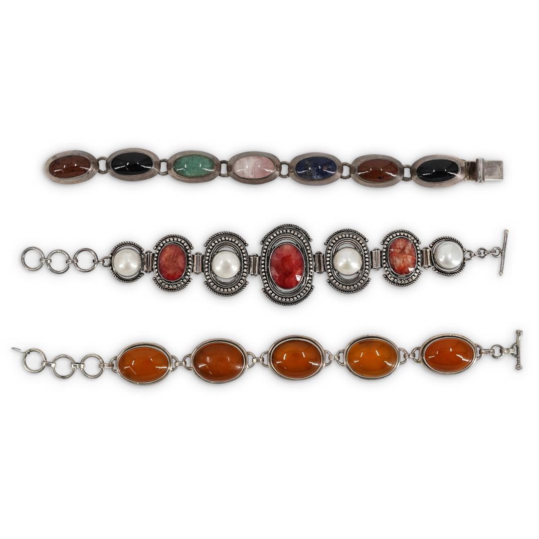 (3 Pc) Vintage Sterling and Gemstone Bracelets: DESCRIPTION: A group three sterling silver linked bracelets decorated with Mother of Pearl, Cornelian, and other Gemstones. Stamped "925". Total Weight: 145 Grams CIRCA: Mid-Late 20th Cent. ORIGIN: Co