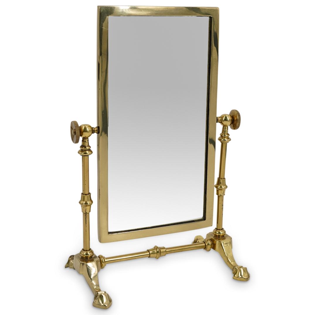 Brass Rotating Mirror: DESCRIPTION: Rectangular mirror in brass horizontally rotating frame. Sticker on foot says "MADE IN TAIWAN REPUBLIC OF CHINA" CIRCA: 20th Century. ORIGIN: Taiwan DIMENSIONS: L: 8.5" W: 6" H: 13.75". H