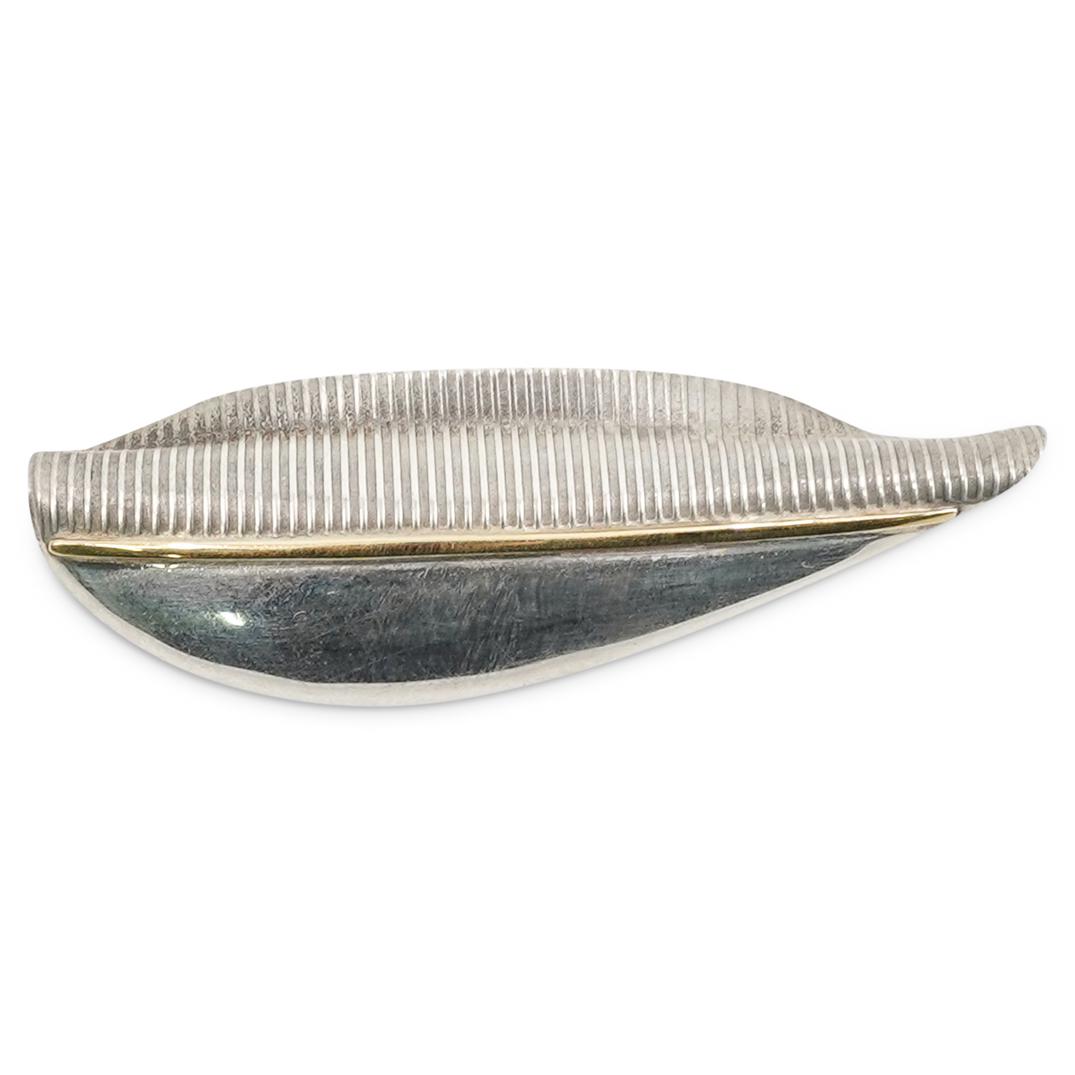 J. Bohan Silver and Gold Pin: DESCRIPTION: J. Bohan silver and gold pin with abstract design. Pin is mostly silver with a line of gold down its center. Back engraved with "J BOHAN 925 18K". CIRCA: 20th Century. ORIGIN: Unknown DIM