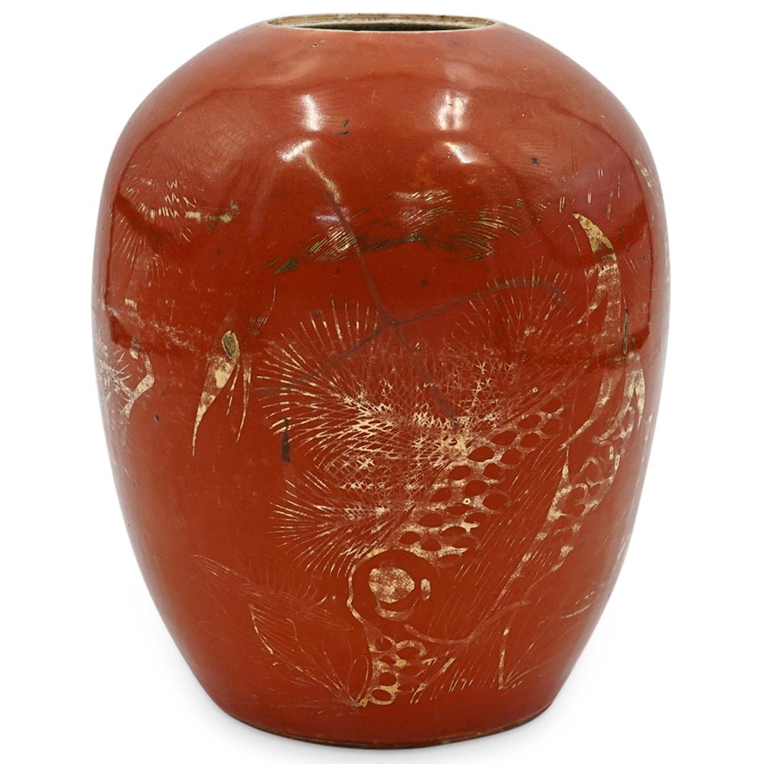 Antique Chinese Porcelain Urn: An antique Chinese Porcelain urn with vibrant orange glazed design. Urn has unglazed kiln fired spots throughout and hand painted gilt decorations along the body. CIRCA: 20th Cent. (Possibly Older) OR