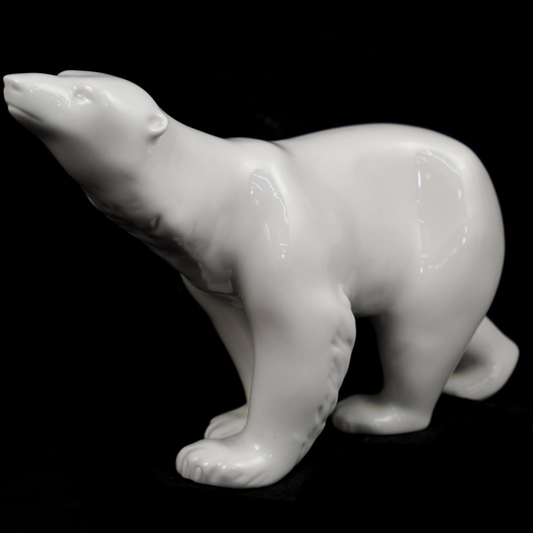 Royal Dux Porcelain Polar Bear: DESCRIPTION: A Royal Dux glazed porcelain polar bear. Marked "Royal Dux Bohemia, made in Czech Republic" and hallmarked on bottom.CIRCA:20th Ct.ORIGIN:Czech RepublicDIMENSIONS:H:7.25" x L:14" x W:3.5"
