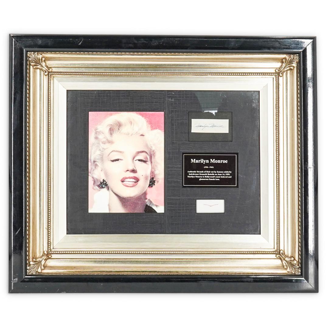 Marilyn Monroe Small Lock of Hair & Signature: DESCRIPTION: Marilyn Monroe small lock of hair and signature. Obtained by Hairdresser Kenneth Battelle on June 14th 1959. Mounted in ornate black lacquer and silver toned display frame. Includes certi